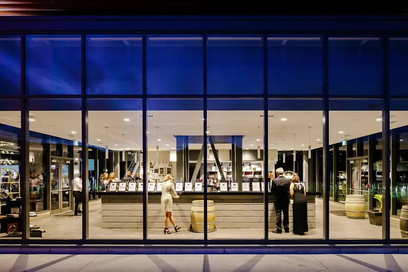 The tasting room seen through its glass walls at night
